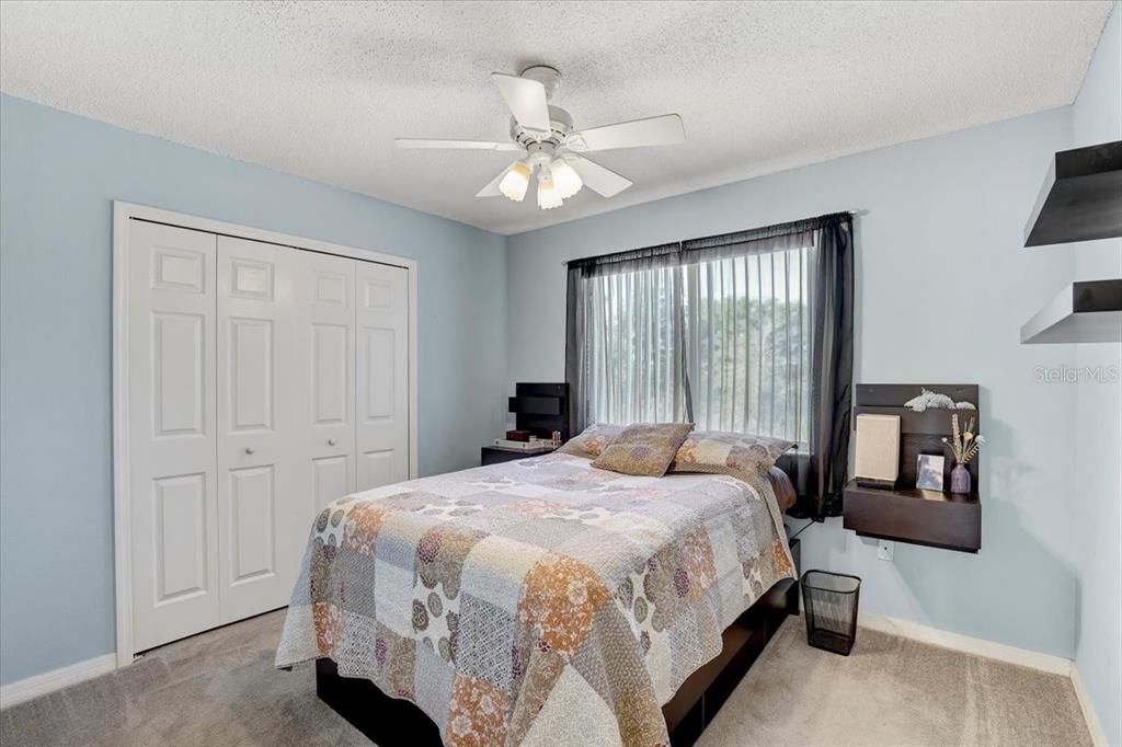 12657 Longcrest Drive Riverview, FL 33579 - Photo 24 of 55 a bedroom with a bed lamps and a large mirror