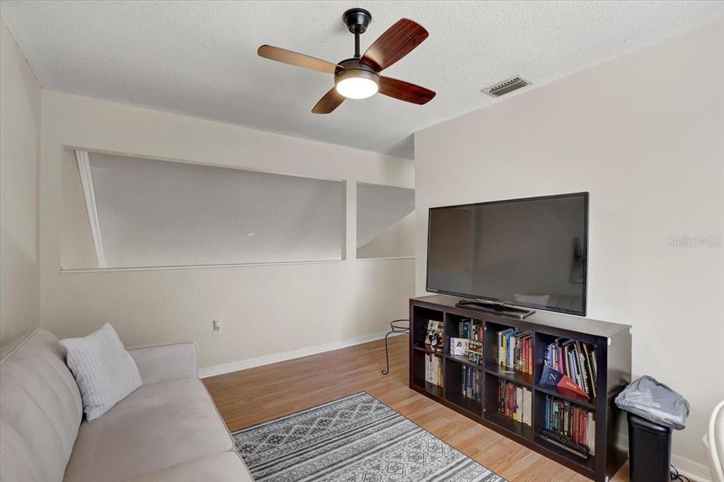 12657 Longcrest Drive Riverview, FL 33579 - Photo 32 of 55 a living room with furniture and a flat screen tv