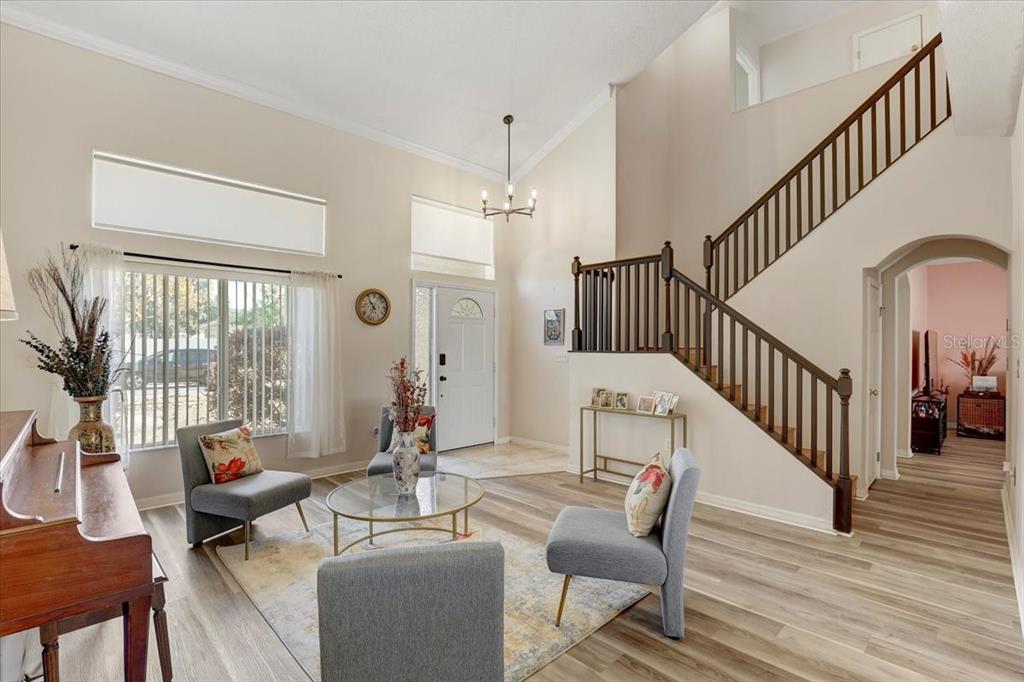 12657 Longcrest Drive Riverview, FL 33579 - Photo 7 of 55 a living room with couches chairs and view of living room with wooden floor