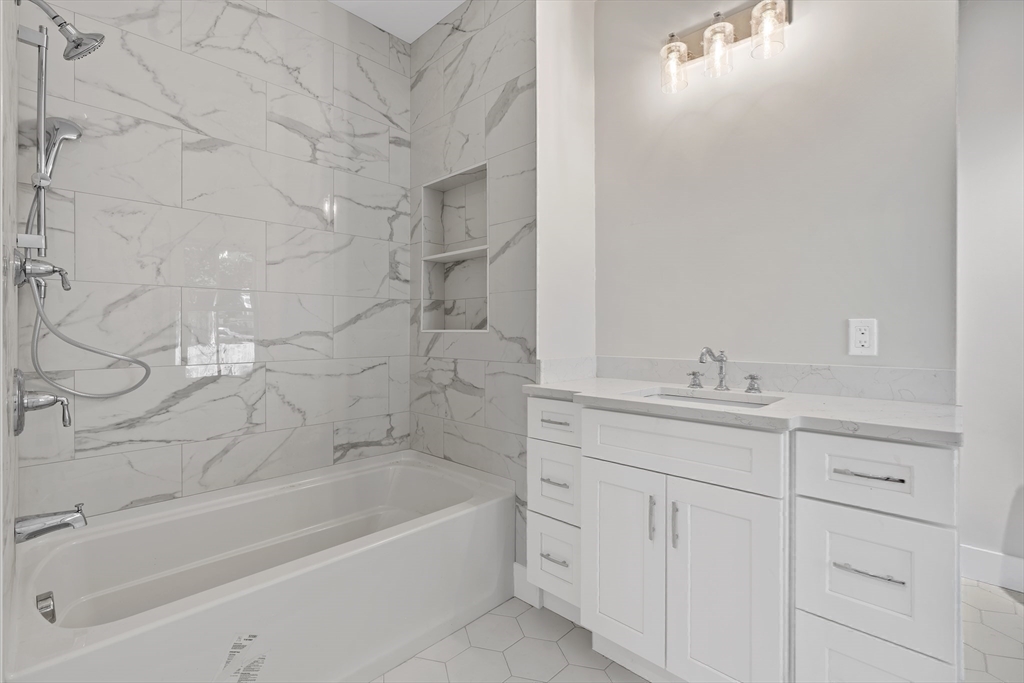 83 Eliot Street Natick, MA 01760 - Photo 25 of 30 a bathroom with a bathtub and a sink