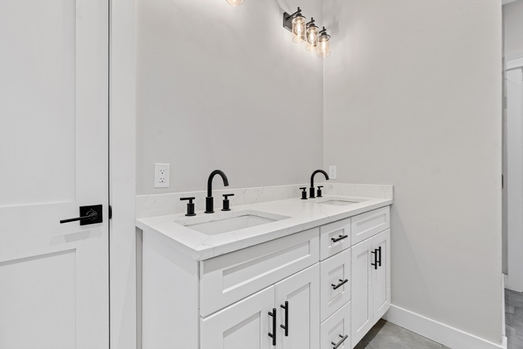 83 Eliot Street Natick, MA 01760 - Photo 26 of 30 a bathroom with a sink and a mirror