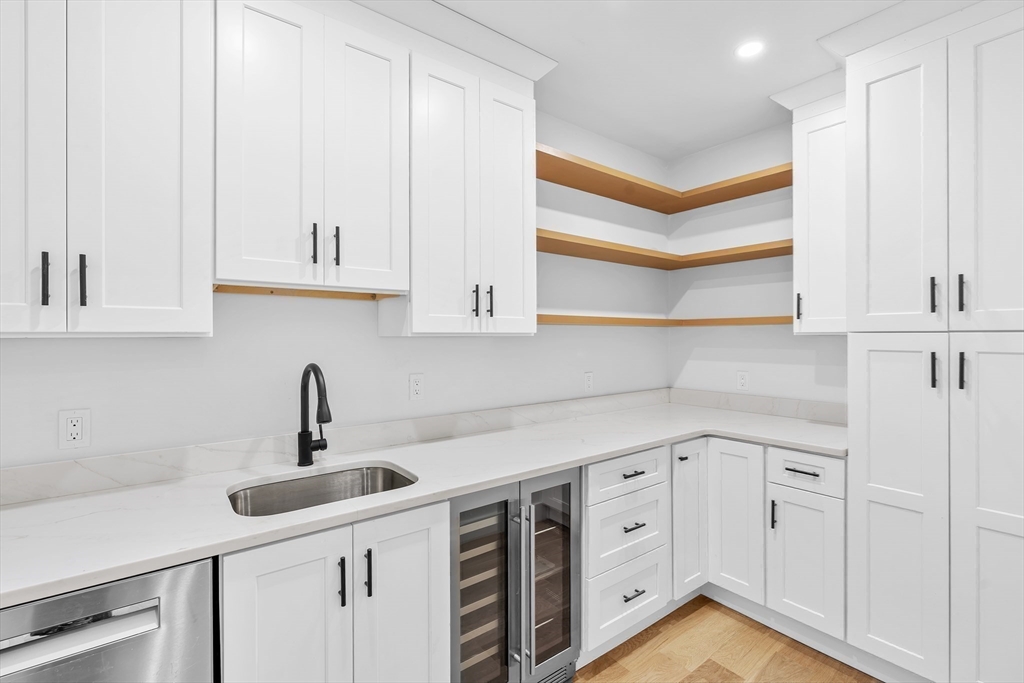 83 Eliot Street Natick, MA 01760 - Photo 10 of 30 a kitchen with white cabinets and sink