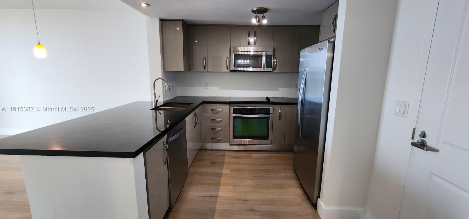 a kitchen with a refrigerator and a stove