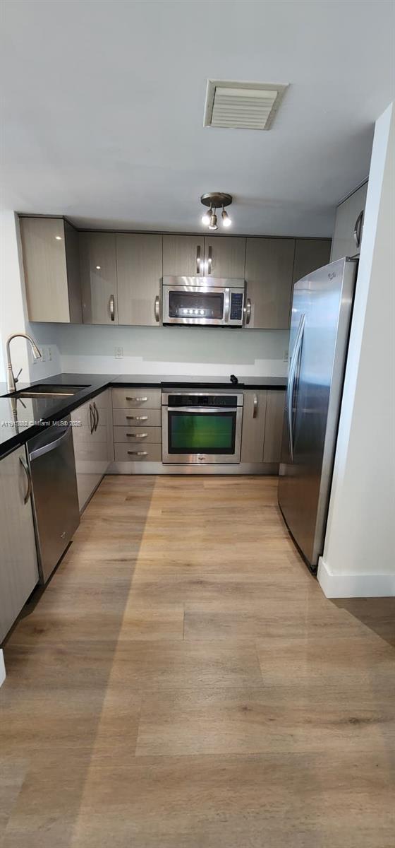 1250 South Miami Avenue, Unit 1911 Miami, FL 33130 - Photo 3 of 23 a kitchen with stainless steel appliances granite countertop a stove a sink and a refrigerator
