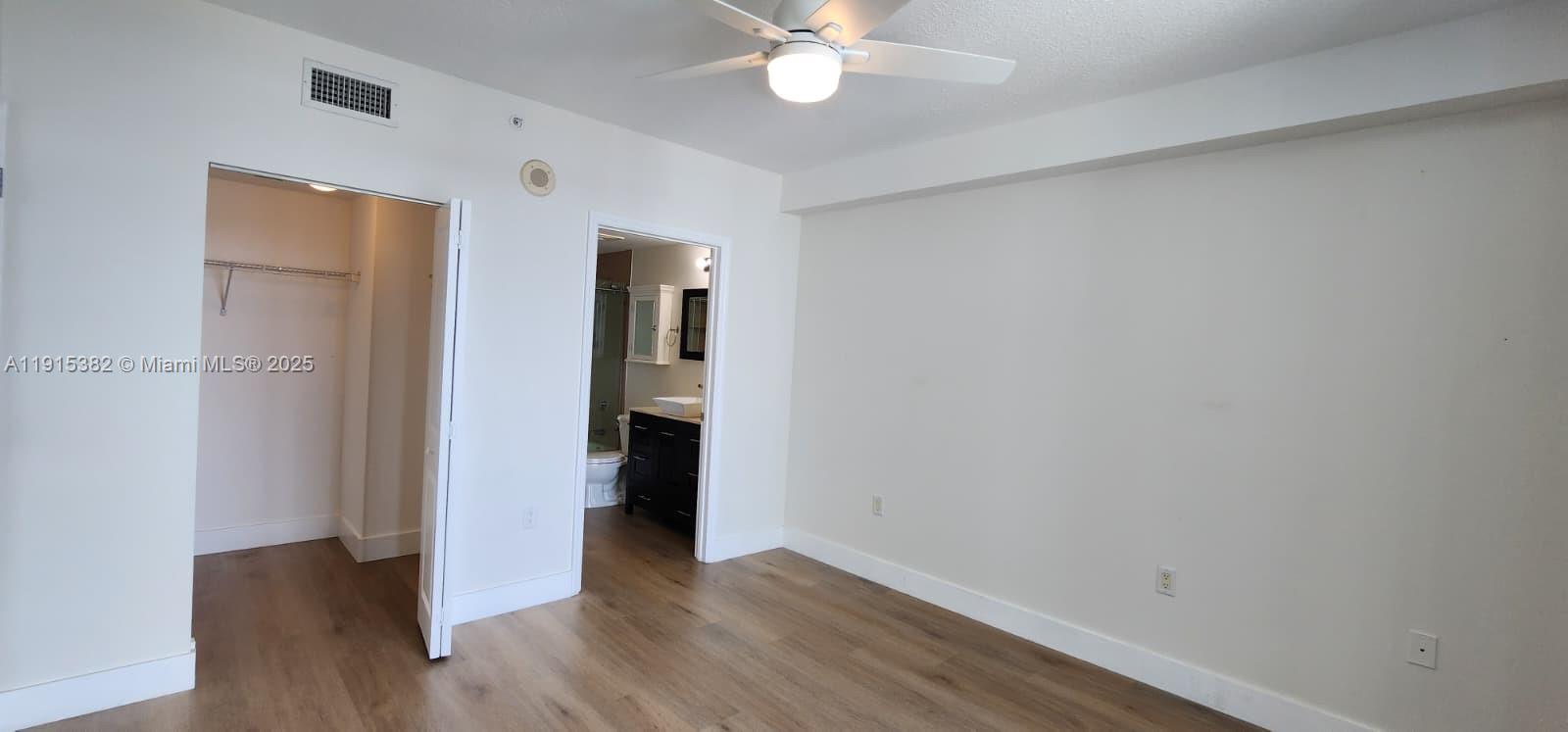 1250 South Miami Avenue, Unit 1911 Miami, FL 33130 - Photo 8 of 23 a view of an empty room with wooden floor