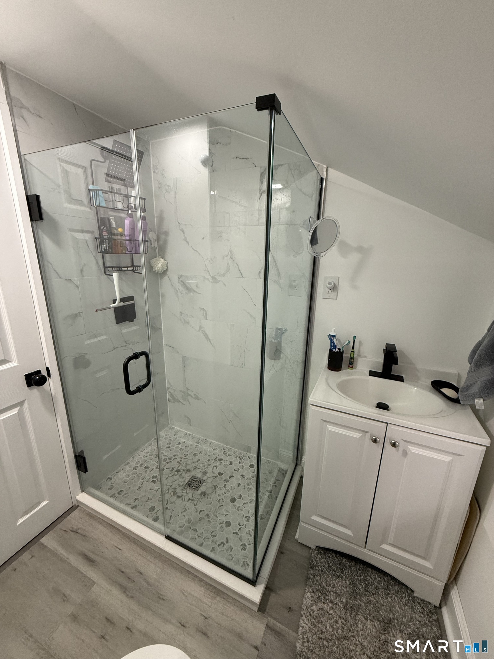 a bathroom with a shower and a sink