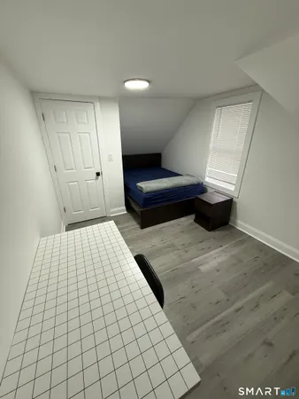 a bedroom with a bed and a night stand