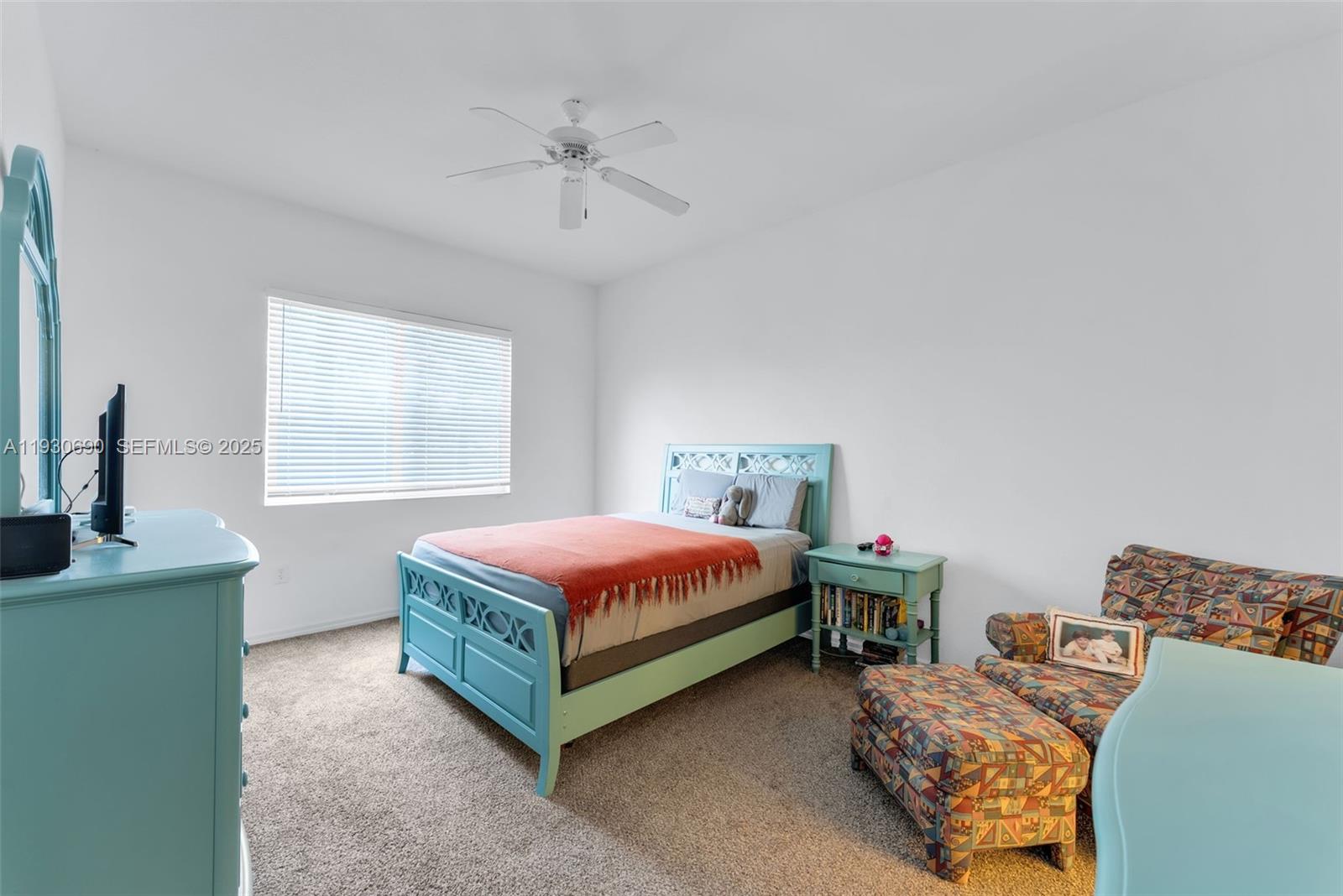 3600 Oaks Clubhouse Drive, Unit 103 Pompano Beach, FL 33069 - Photo 11 of 16 a spacious bedroom with a bed and a chandelier
