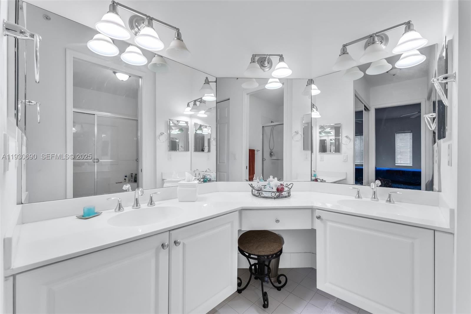 3600 Oaks Clubhouse Drive, Unit 103 Pompano Beach, FL 33069 - Photo 12 of 16 a bathroom with a sink double vanity and a mirror