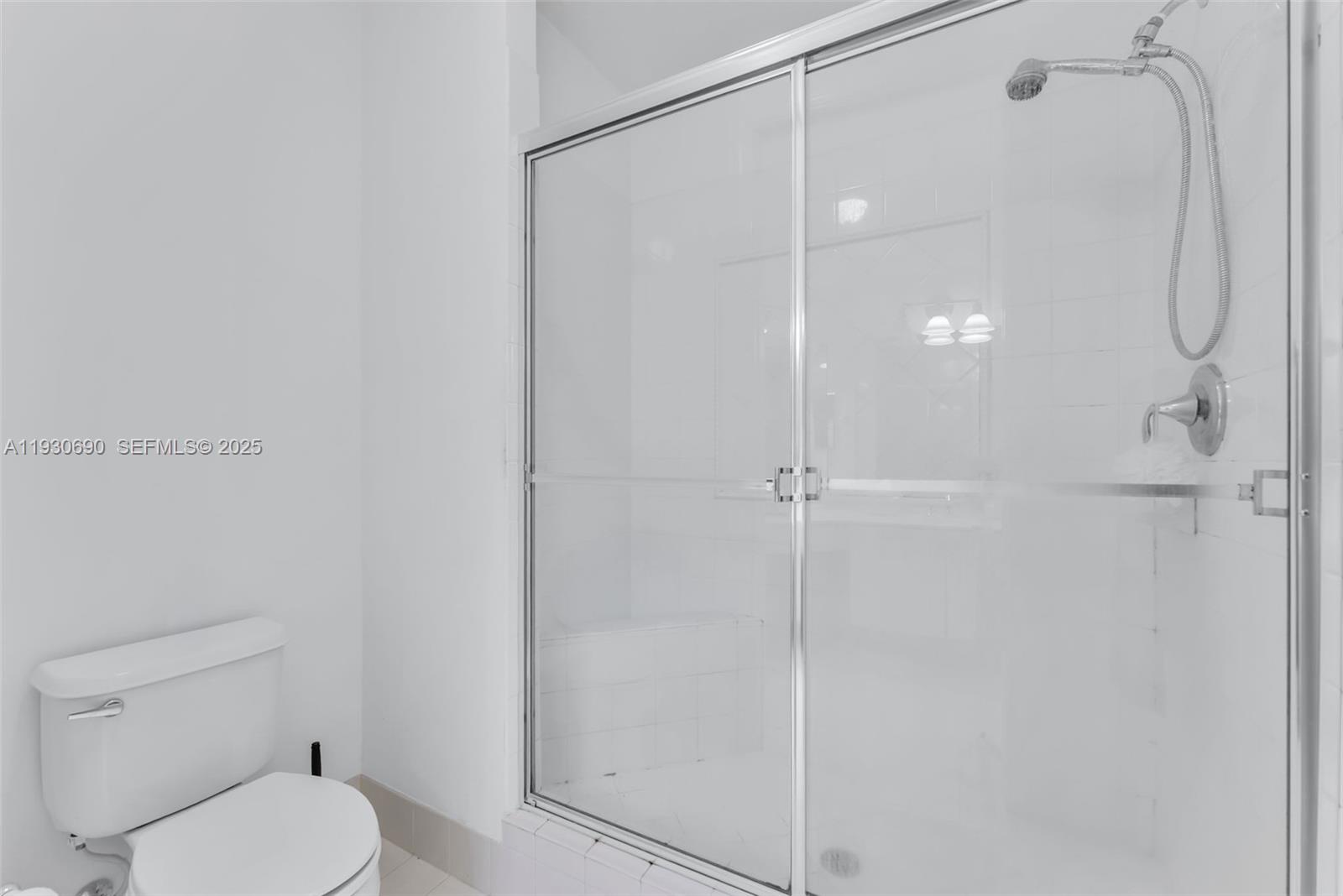 3600 Oaks Clubhouse Drive, Unit 103 Pompano Beach, FL 33069 - Photo 13 of 16 a bathroom with a shower and a toilet