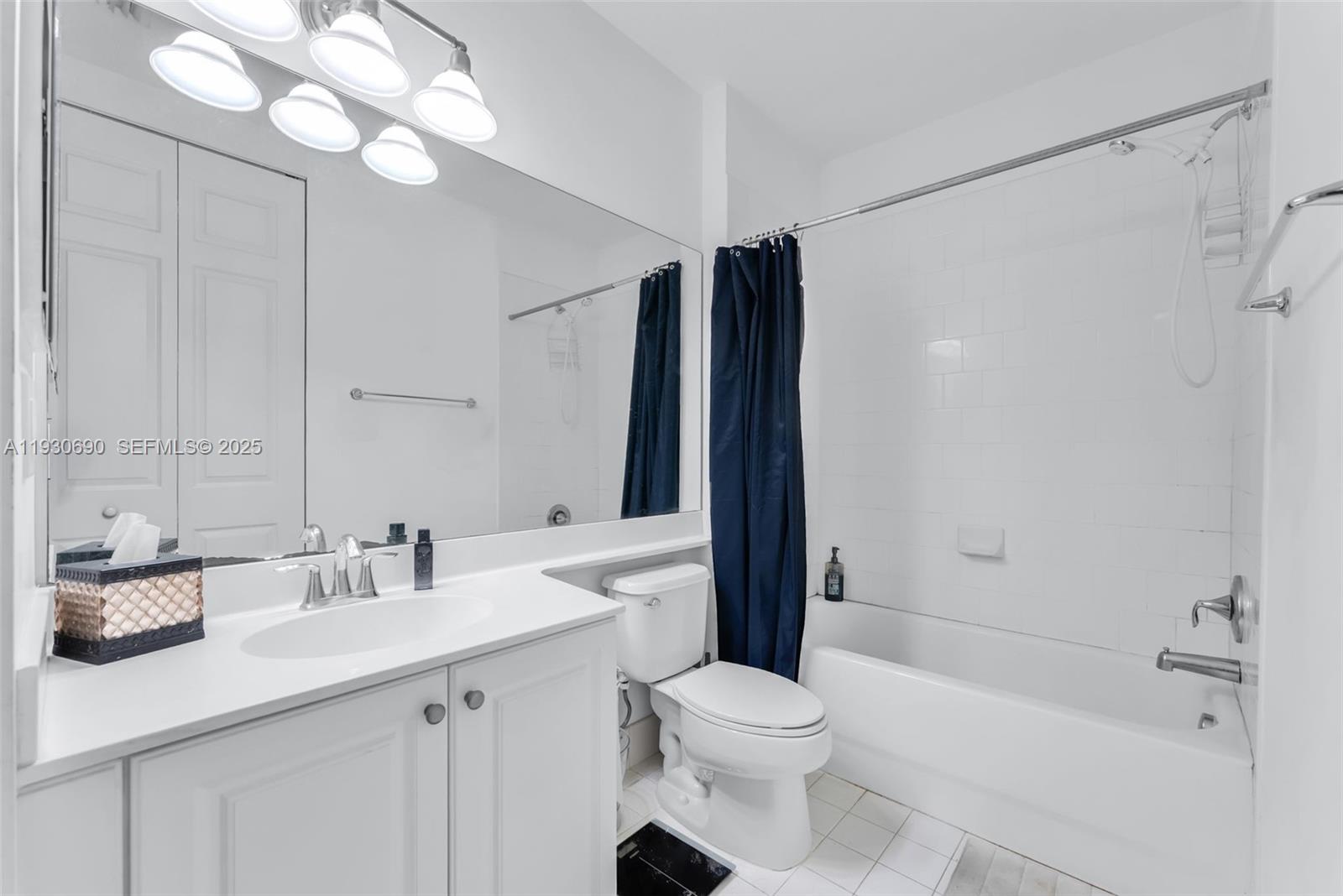 3600 Oaks Clubhouse Drive, Unit 103 Pompano Beach, FL 33069 - Photo 15 of 16 a bathroom with a sink a toilet and shower