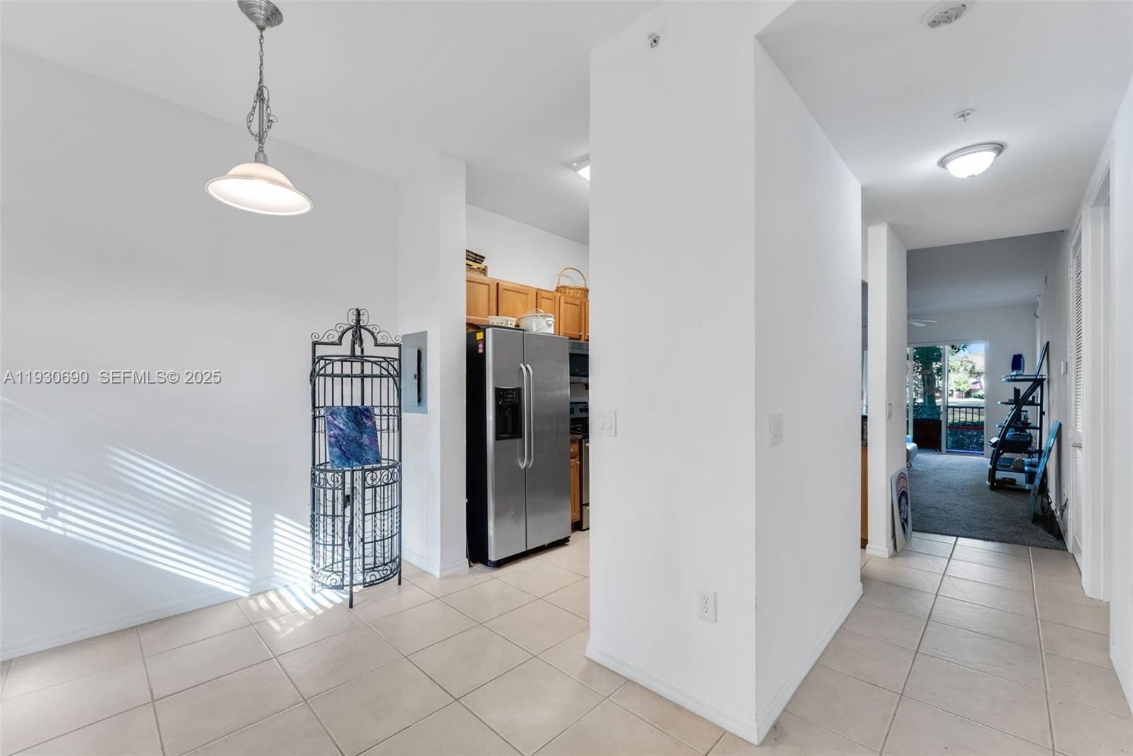 3600 Oaks Clubhouse Drive, Unit 103 Pompano Beach, FL 33069 - Photo 6 of 16 a view of a kitchen and refrigerator in a kitchen