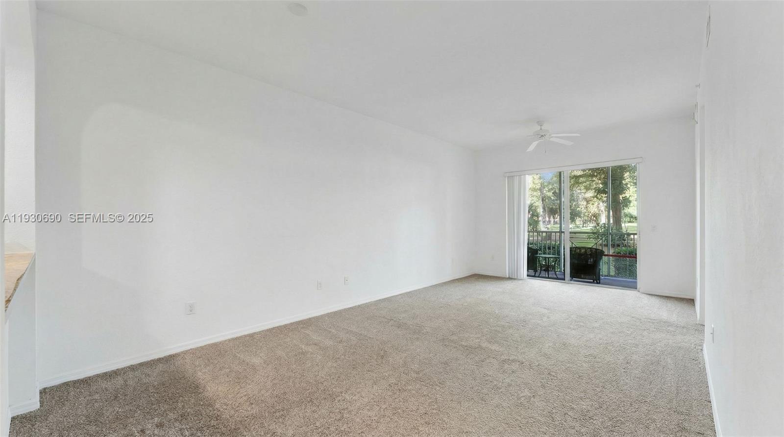 3600 Oaks Clubhouse Drive, Unit 103 Pompano Beach, FL 33069 - Photo 9 of 16 a view of an empty room with a balcony