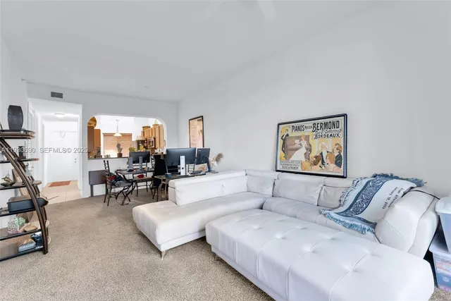 a spacious bedroom with a bed and a chandelier
