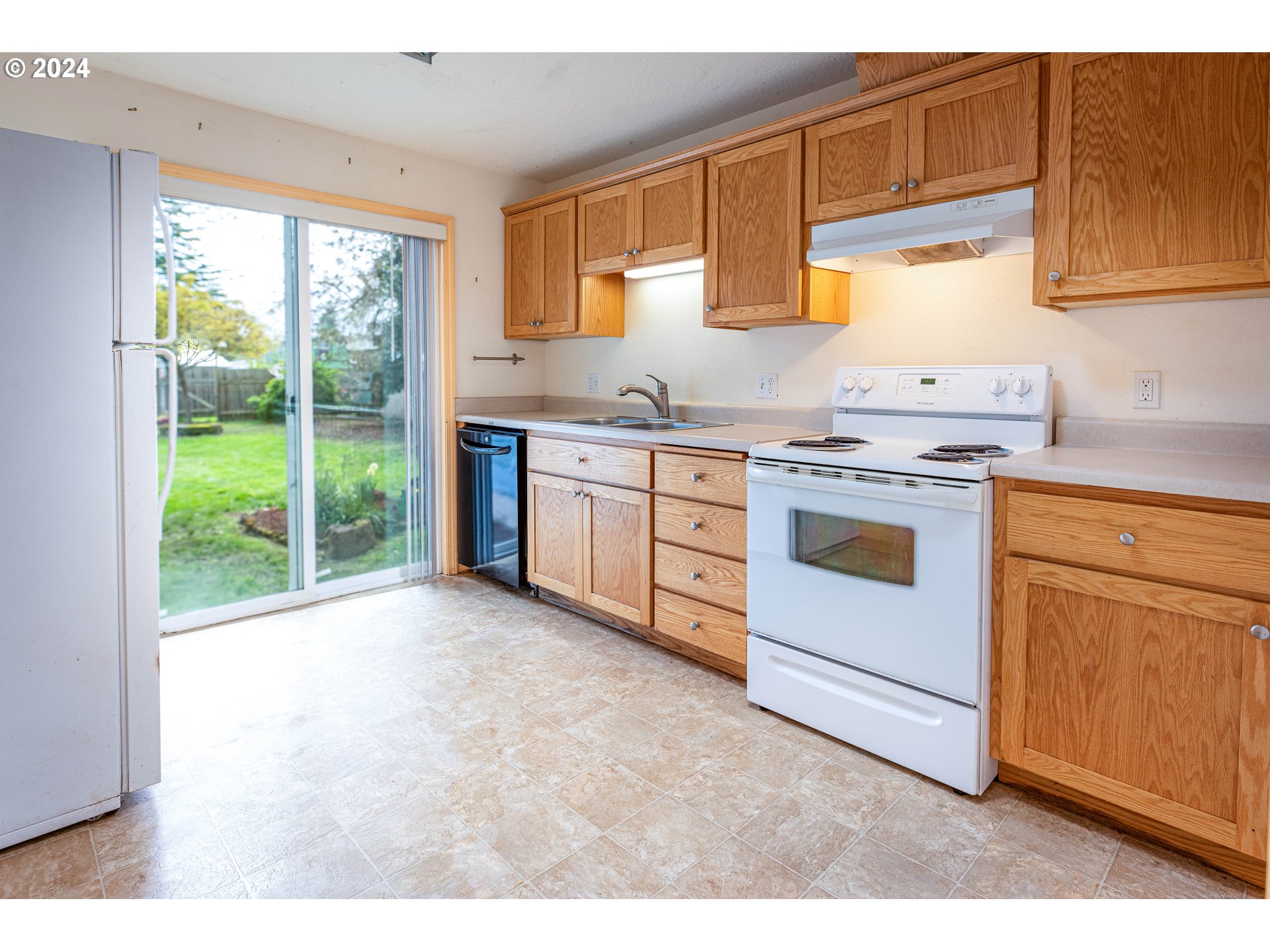1159 M Street Springfield, OR 97477 - Photo 11 of 16 a kitchen with a stove a sink and a microwave