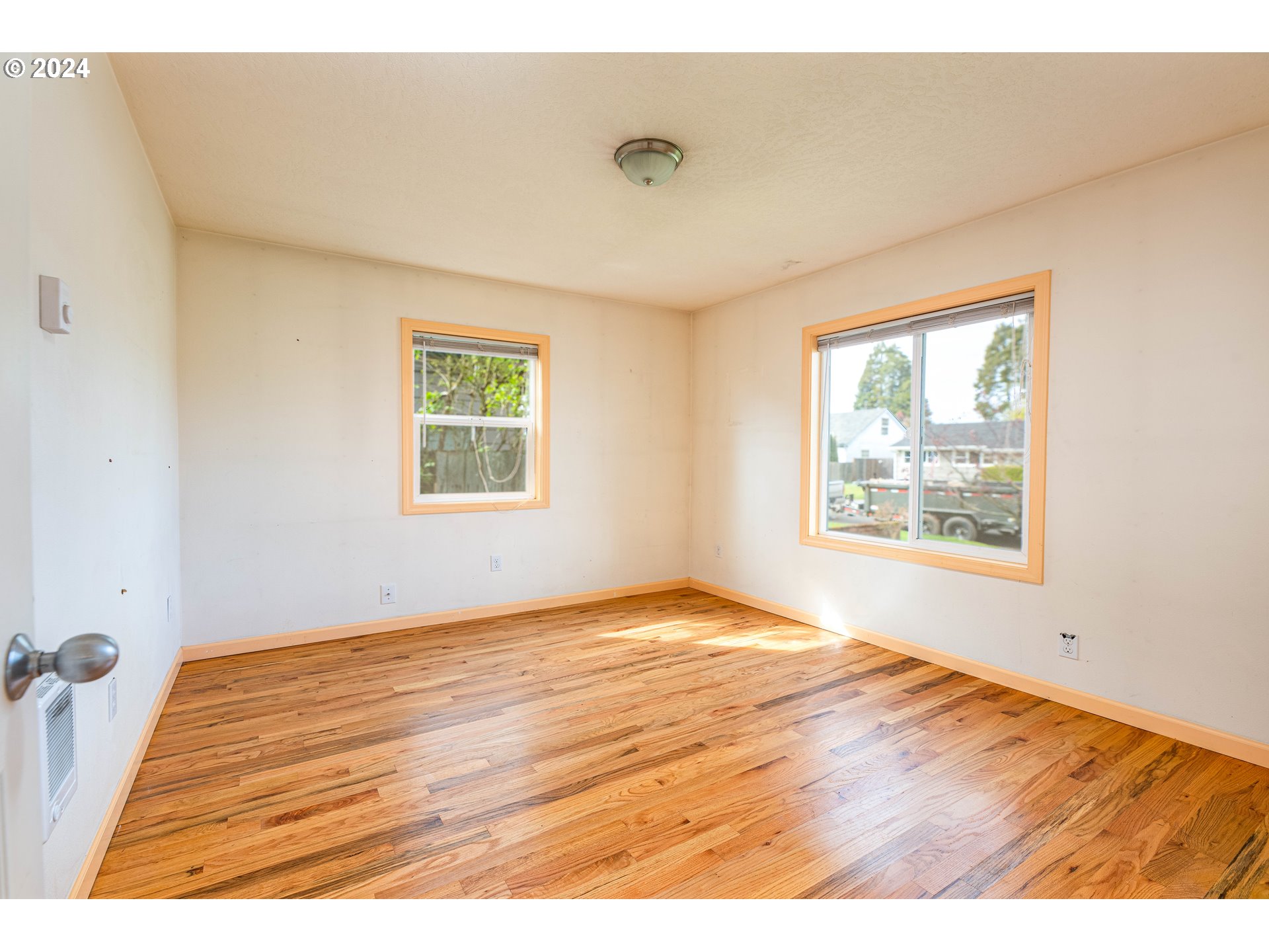 1159 M Street Springfield, OR 97477 - Photo 16 of 16 a view of an empty room with wooden floor and a window