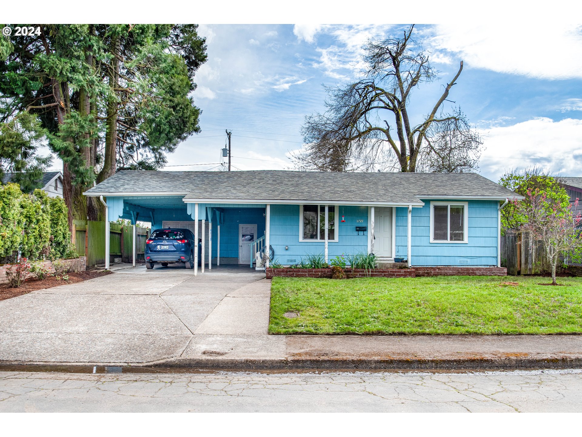1159 M Street Springfield, OR 97477 - Photo 2 of 16 a front view of a house with a garden and patio