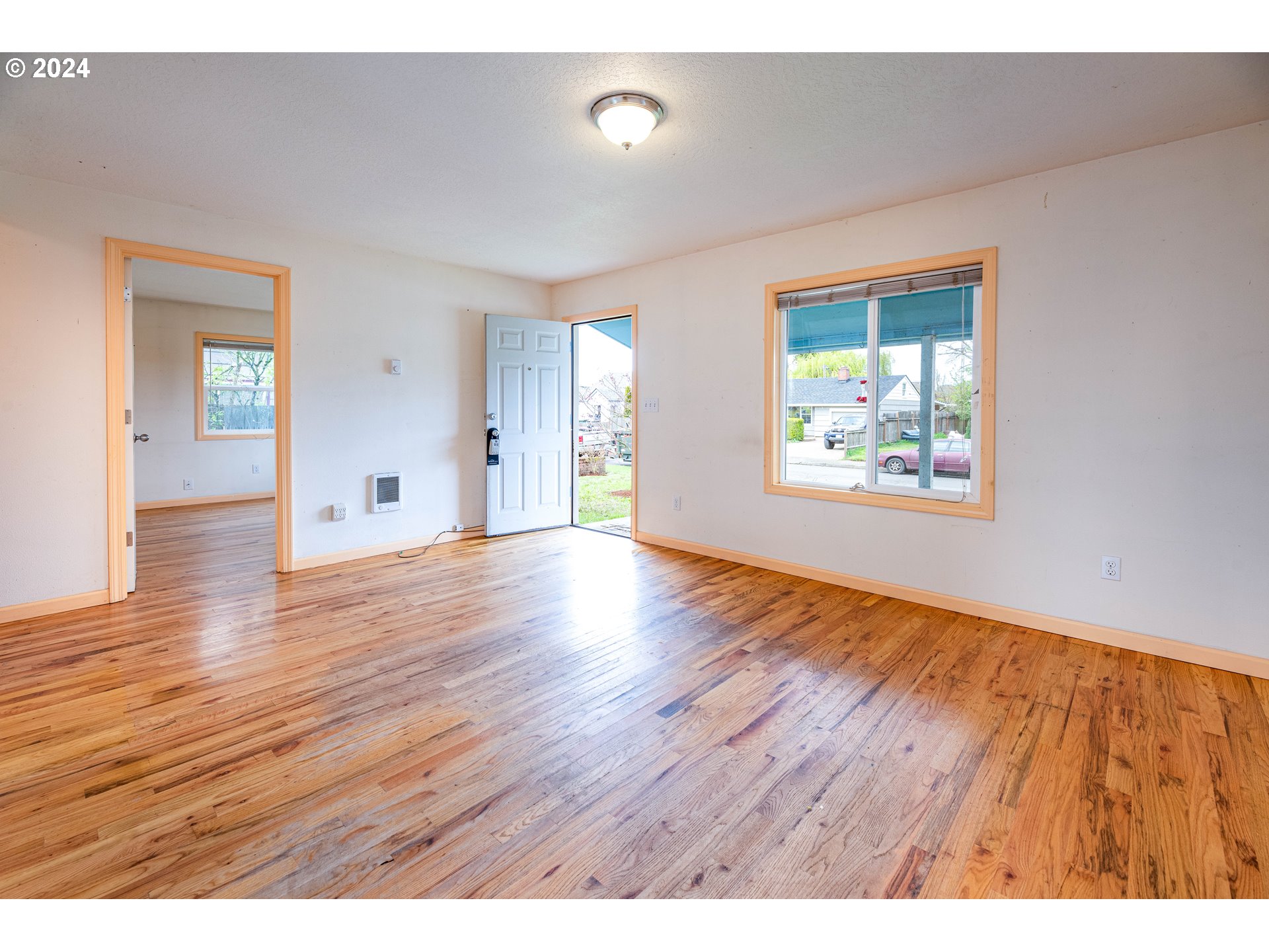 1159 M Street Springfield, OR 97477 - Photo 9 of 16 an empty room with wooden floor and windows