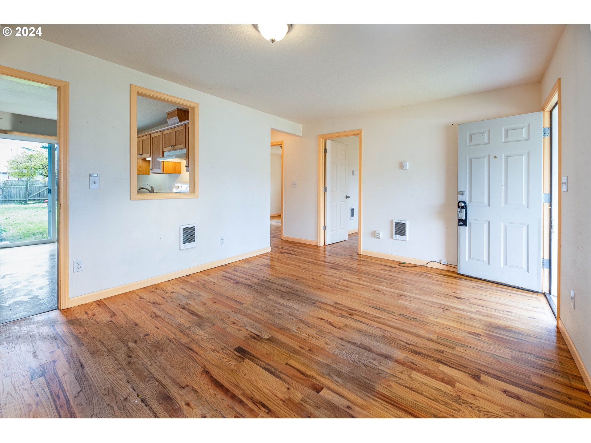 1159 M Street Springfield, OR 97477 - Photo 10 of 16 a view of empty room with wooden floor and window