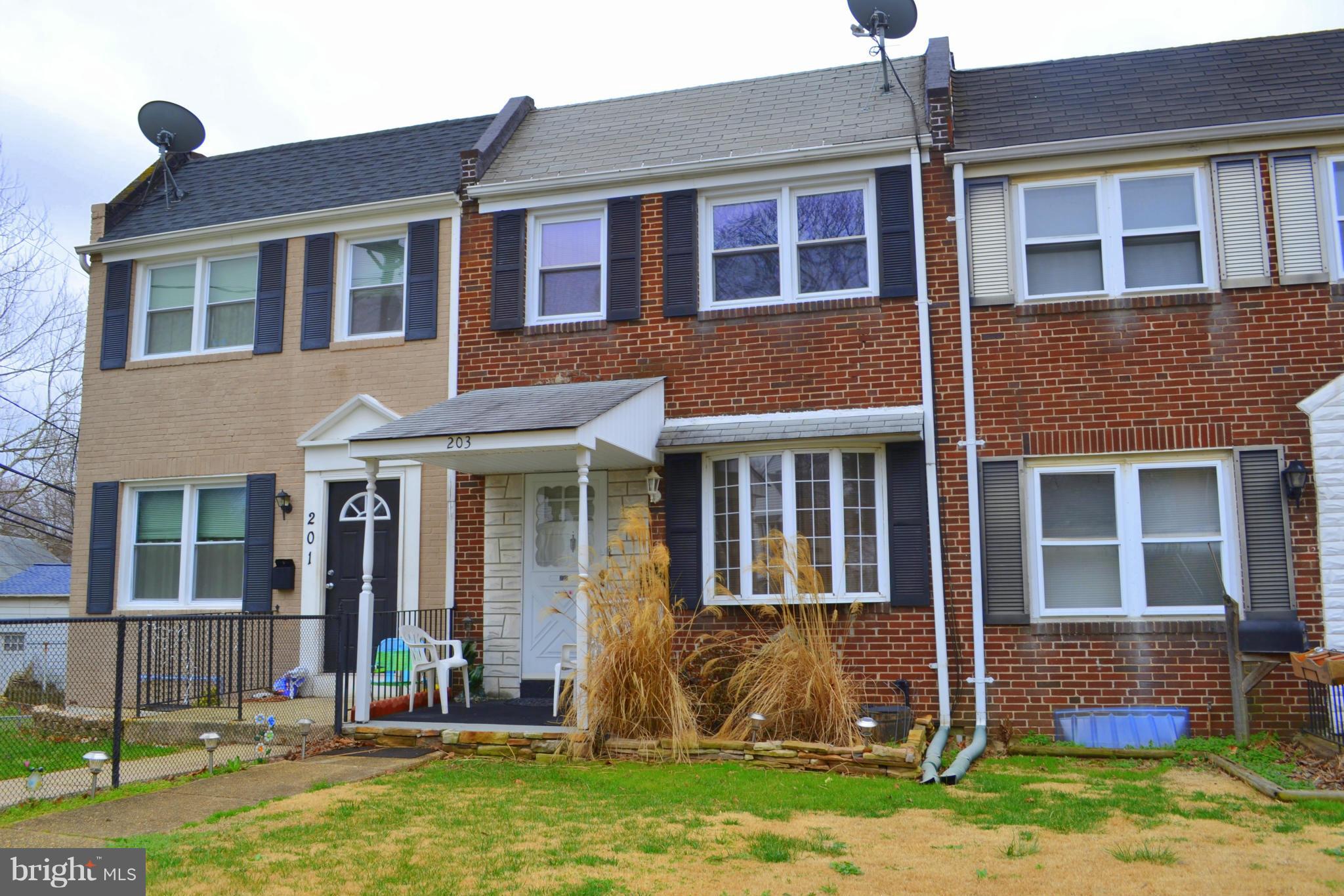203 Grove Park Road Baltimore, MD 21225 - Photo 1 of 23 a front view of a house with a yard