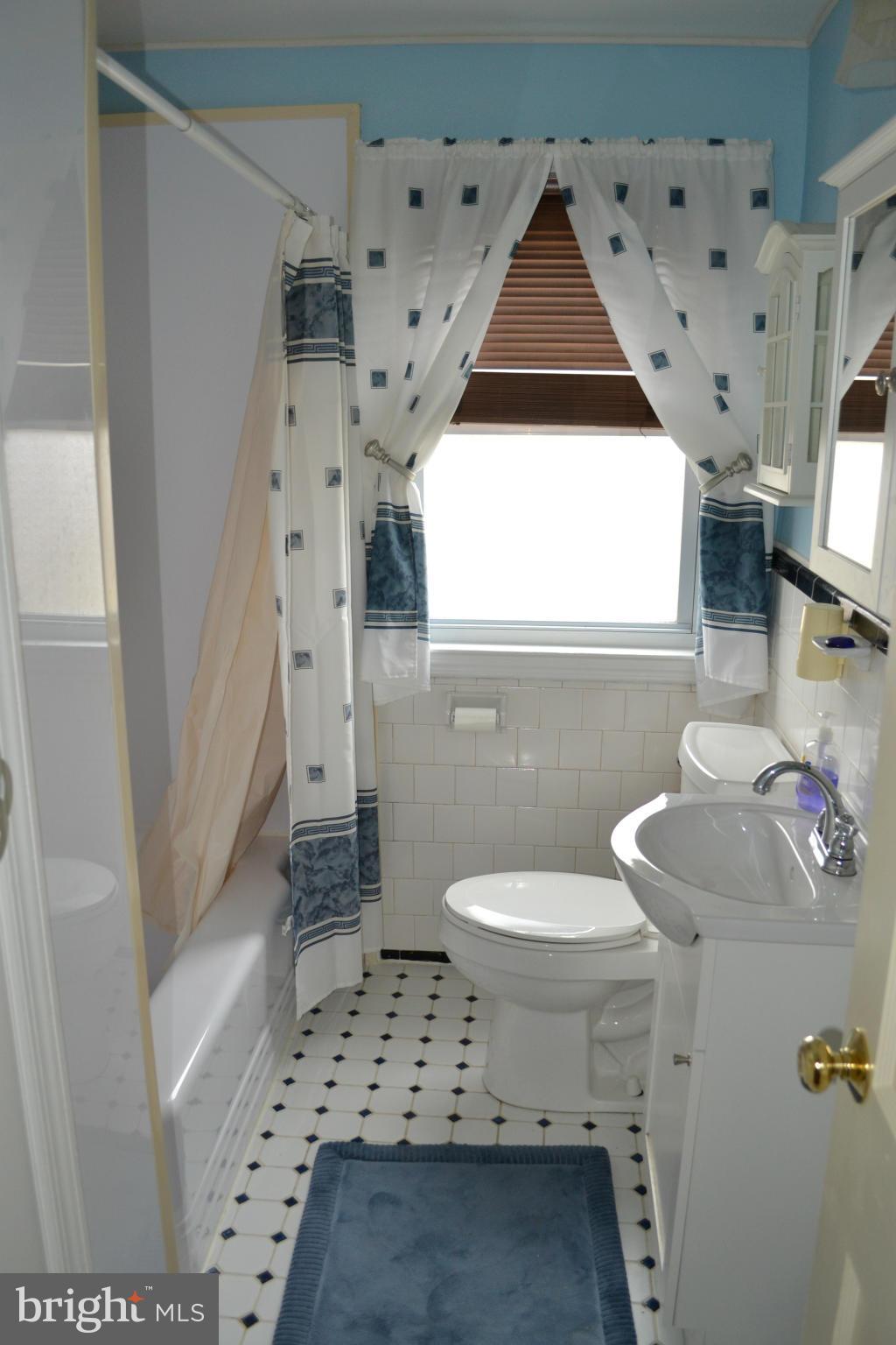 203 Grove Park Road Baltimore, MD 21225 - Photo 15 of 23 a bathroom with a sink toilet and shower