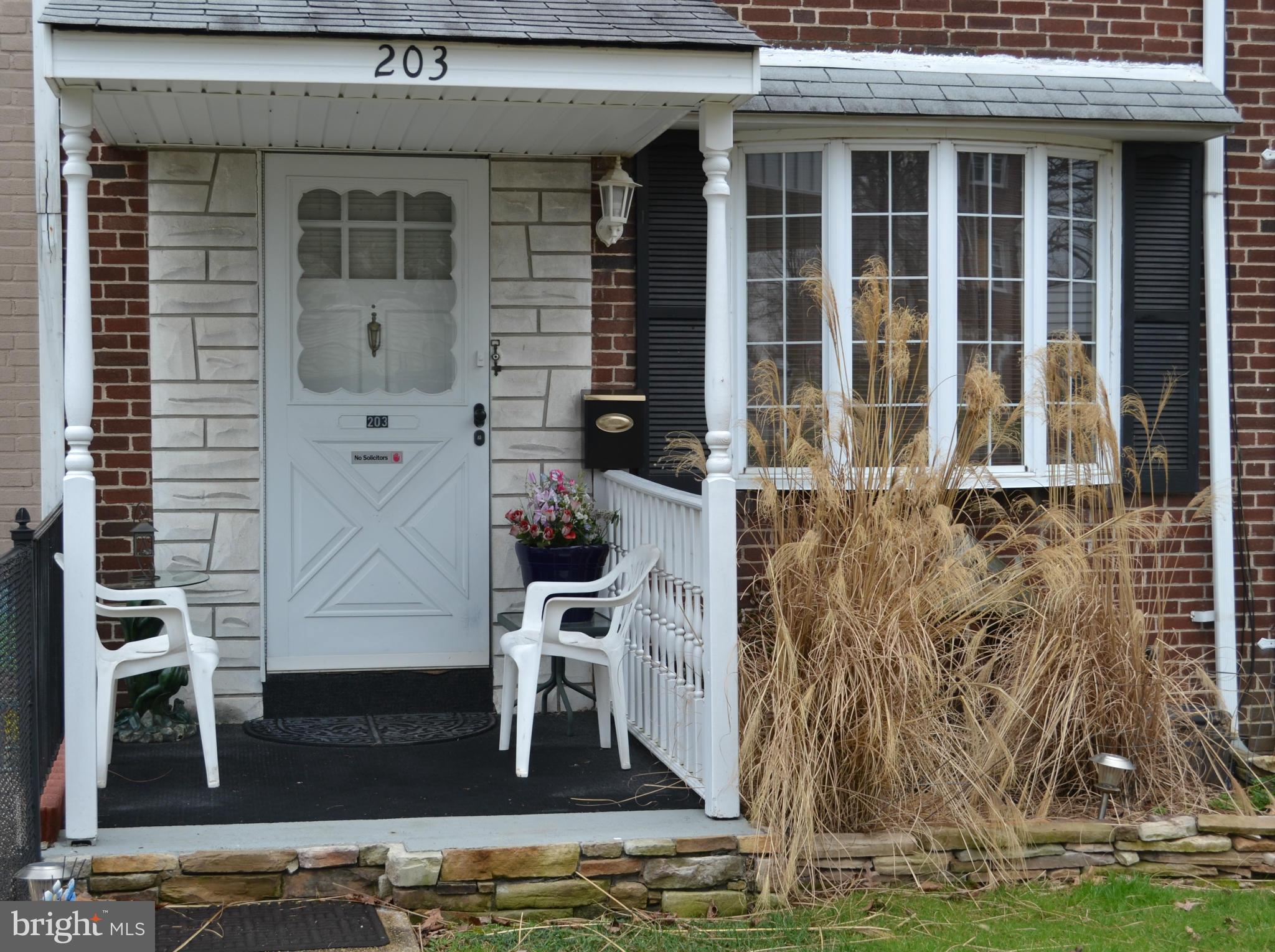 203 Grove Park Road Baltimore, MD 21225 - Photo 2 of 23 a front view of a house with a yard