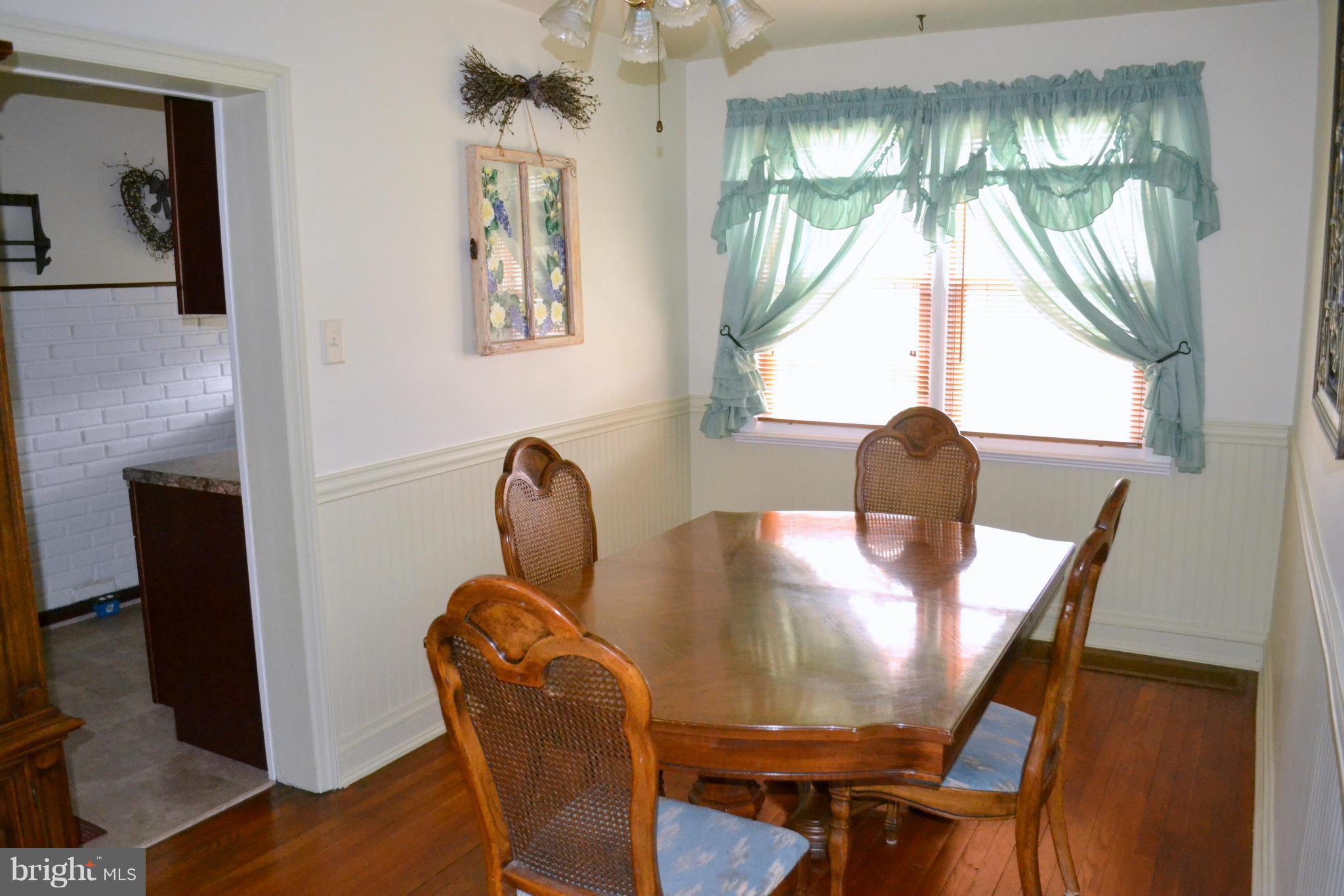 203 Grove Park Road Baltimore, MD 21225 - Photo 9 of 23 a view of a dining room with furniture and a chandelier