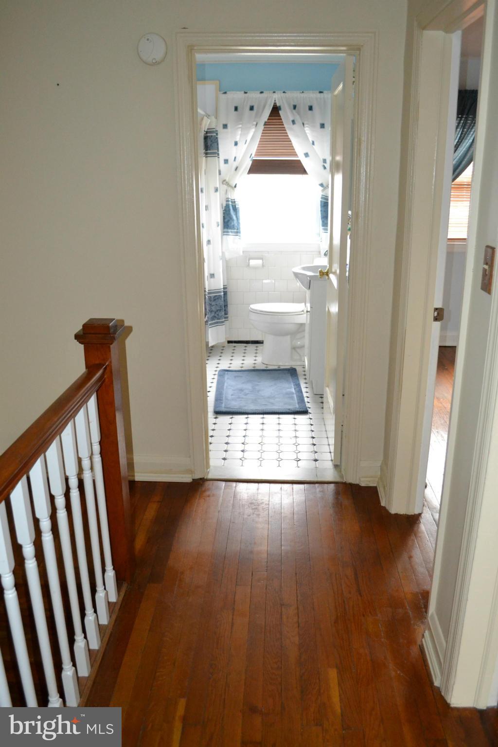 203 Grove Park Road Baltimore, MD 21225 - Photo 10 of 23 a view of empty room with wooden floor and fan