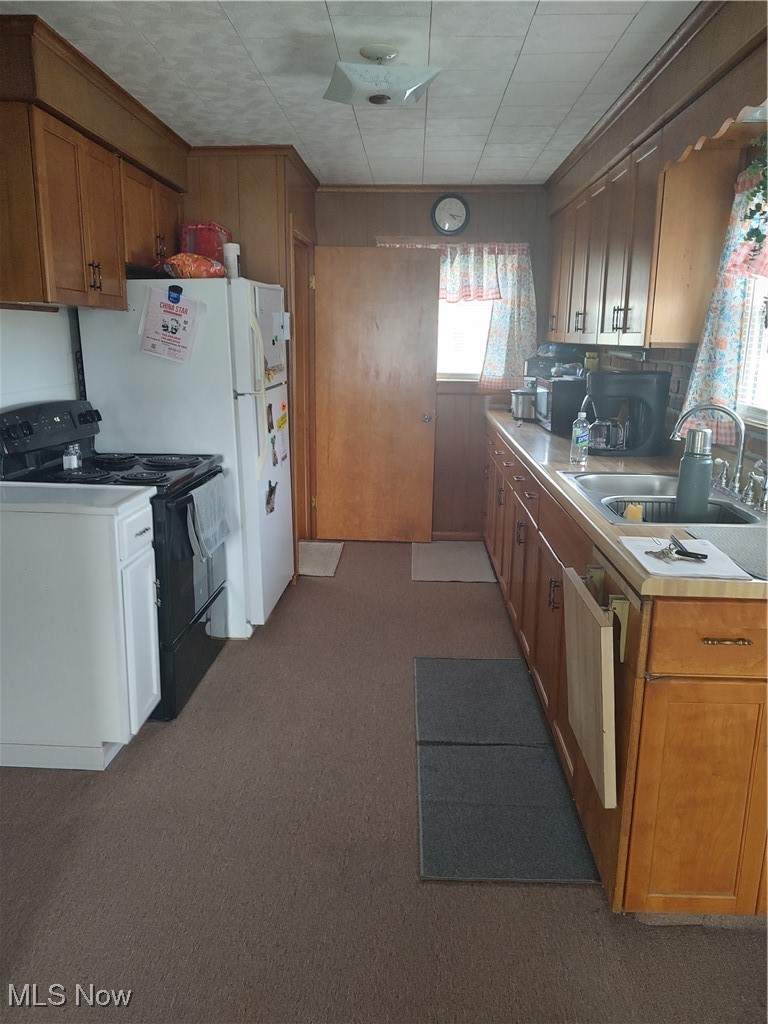 5434 East State Road Newcomerstown, OH 43832 - Photo 12 of 34 Kitchen with ample cabinets, range, refrigerator and open concept to dining room.