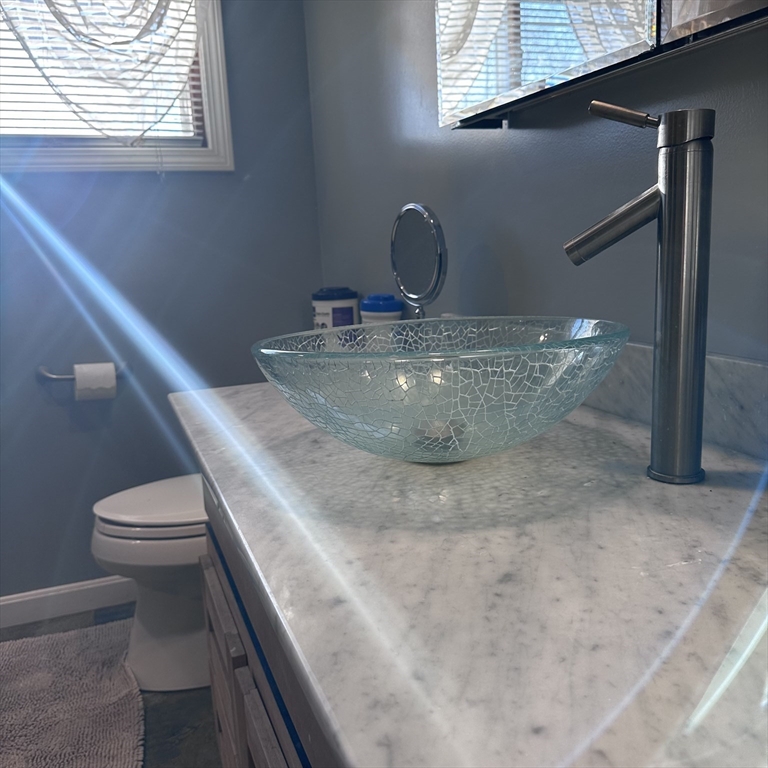 1163 Whipple Road Tewksbury, MA 01876 - Photo 12 of 31 a view of a bathroom with a sink