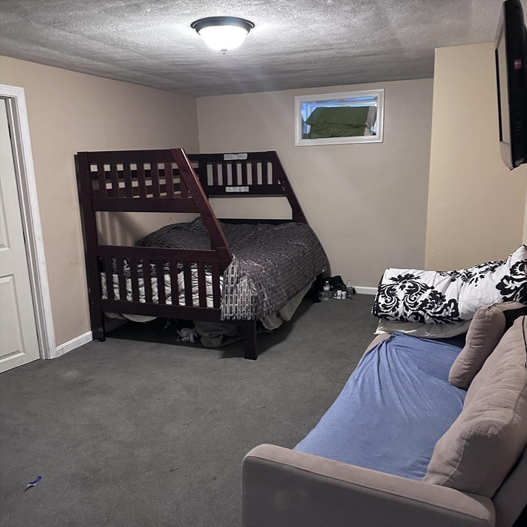 1163 Whipple Road Tewksbury, MA 01876 - Photo 14 of 31 a bedroom with a bed and a couch