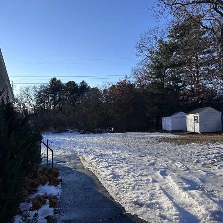 1163 Whipple Road Tewksbury, MA 01876 - Photo 19 of 31 a wooden bench sitting in the middle of a yard