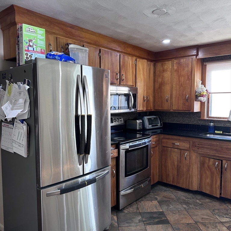 1163 Whipple Road Tewksbury, MA 01876 - Photo 2 of 31 a kitchen with stainless steel appliances granite countertop a refrigerator and a sink