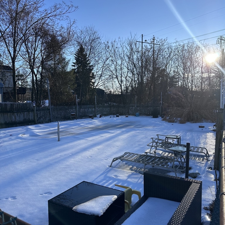 1163 Whipple Road Tewksbury, MA 01876 - Photo 21 of 31 a view of a backyard with wooden floor