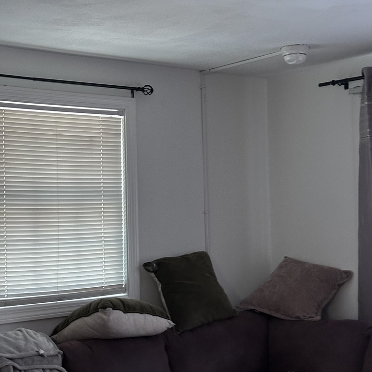 1163 Whipple Road Tewksbury, MA 01876 - Photo 26 of 31 a living room with furniture and a window
