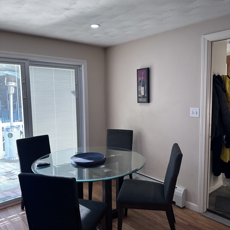 1163 Whipple Road Tewksbury, MA 01876 - Photo 5 of 31 a view of a dining room with furniture and wooden floor