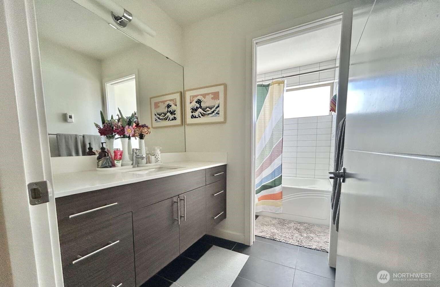 4852 40th Avenue Southwest, Unit B Seattle, WA 98116 - Photo 12 of 25 a bathroom with a sink mirror and a shower