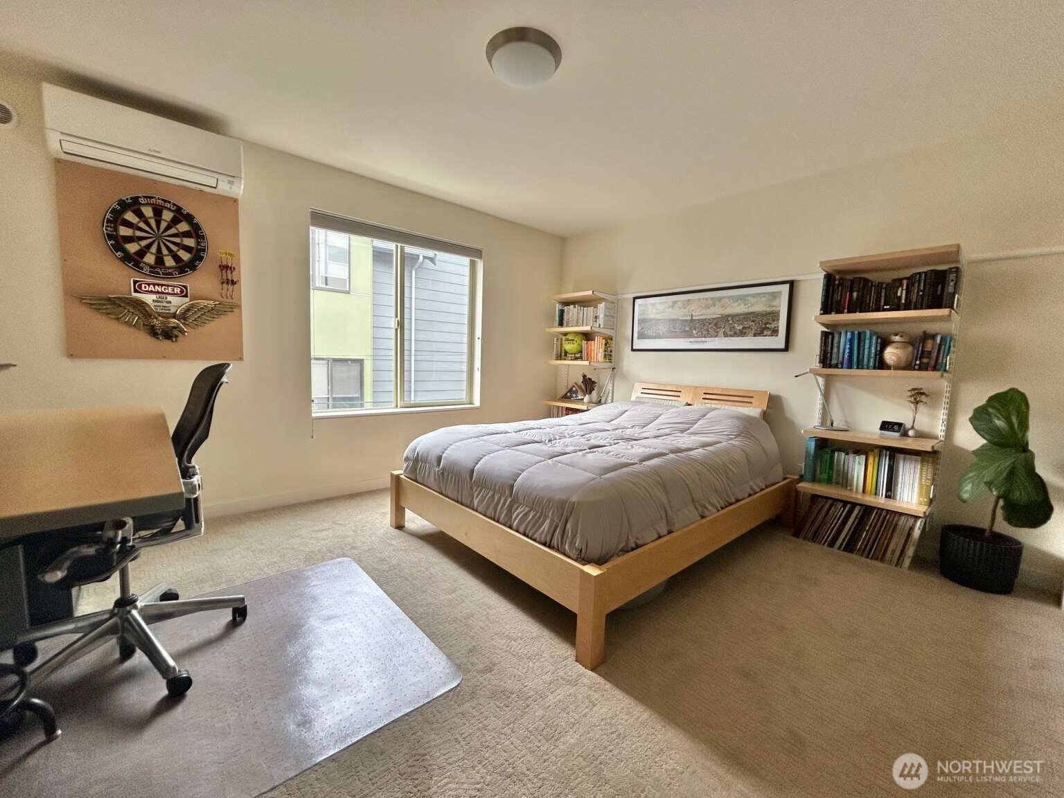 4852 40th Avenue Southwest, Unit B Seattle, WA 98116 - Photo 13 of 25 a bedroom with a bed a table and painting on the wall