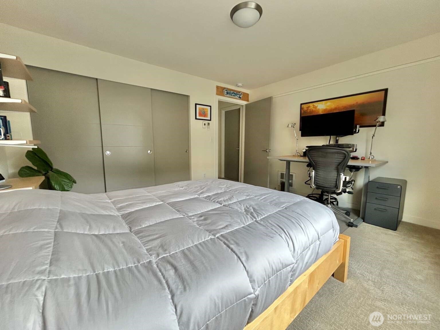 4852 40th Avenue Southwest, Unit B Seattle, WA 98116 - Photo 14 of 25 a bedroom with a bed and a flat screen tv