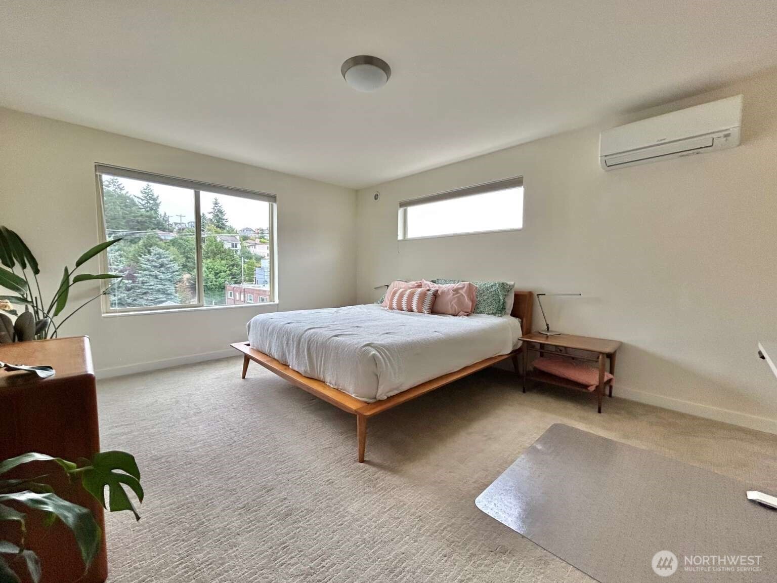 4852 40th Avenue Southwest, Unit B Seattle, WA 98116 - Photo 18 of 25 a bedroom with a bed and large window
