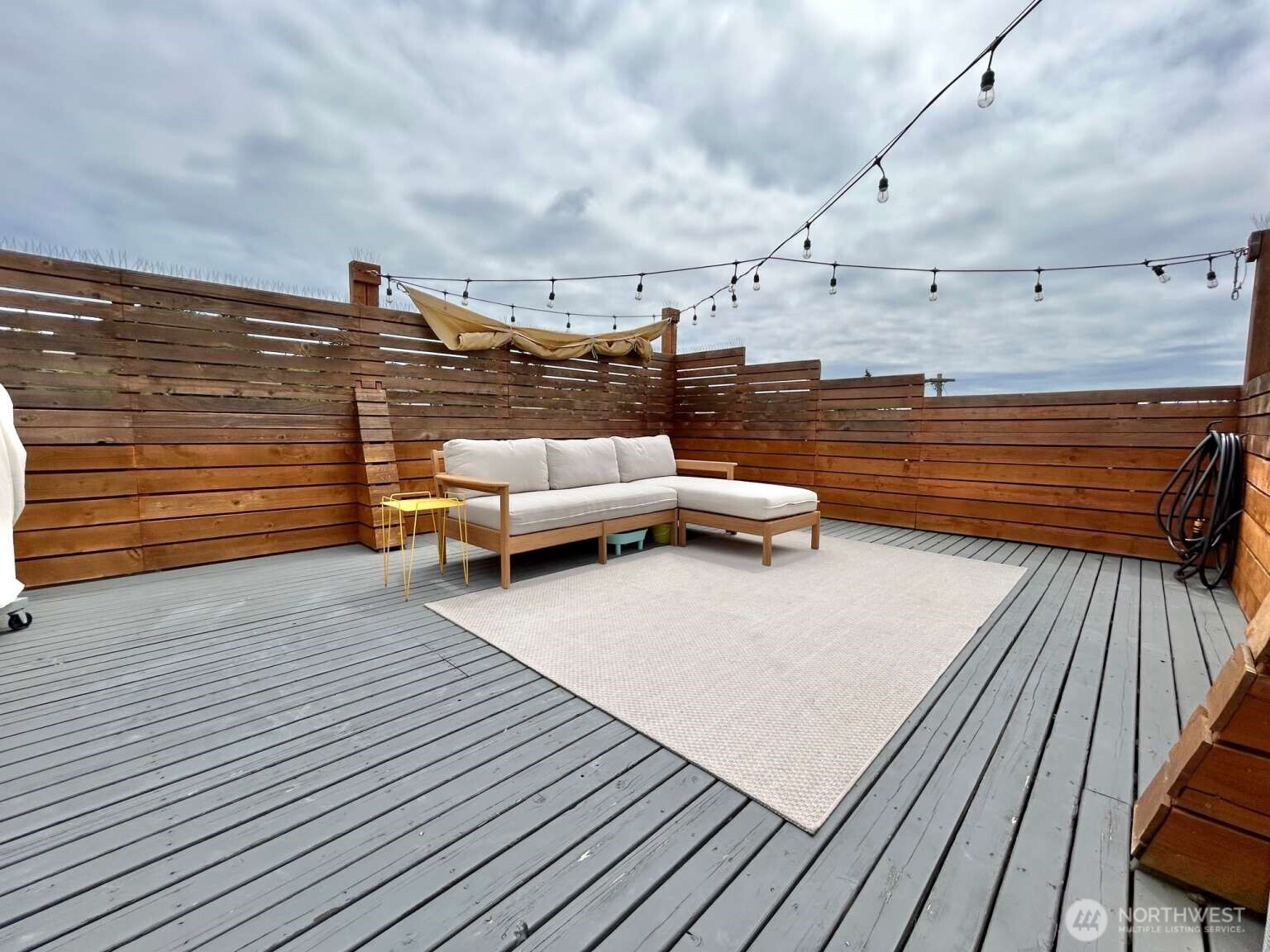 4852 40th Avenue Southwest, Unit B Seattle, WA 98116 - Photo 23 of 25 a roof deck with couch and chairs