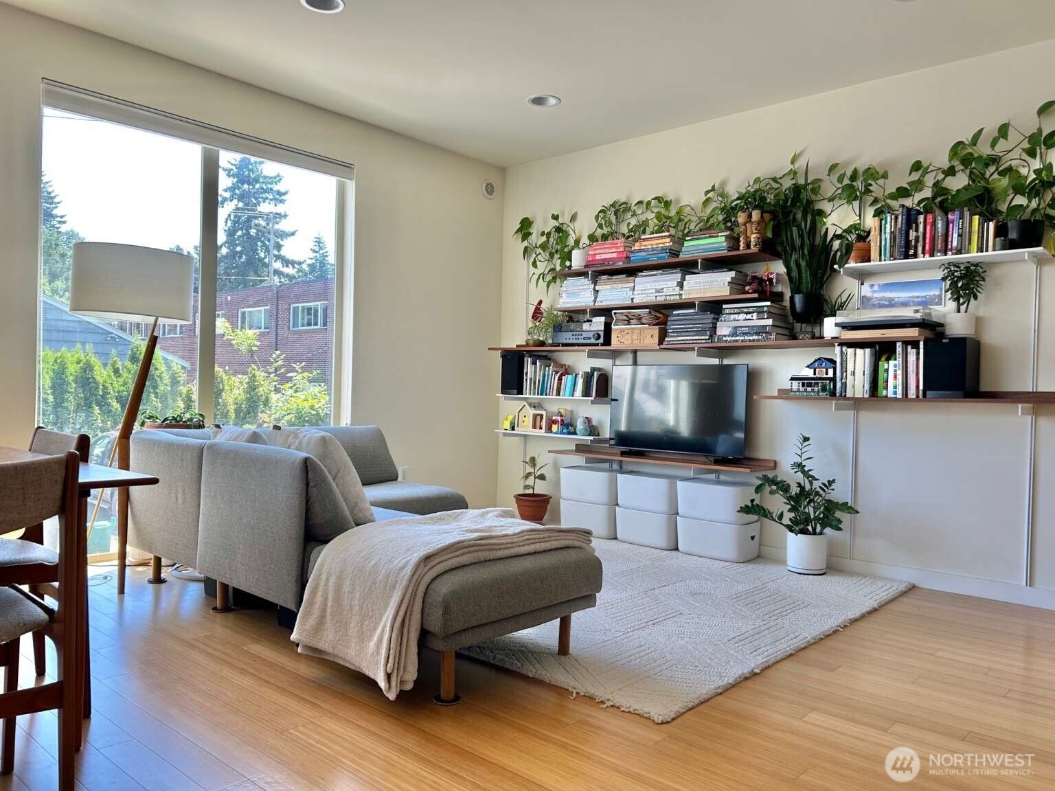 4852 40th Avenue Southwest, Unit B Seattle, WA 98116 - Photo 6 of 25 a bedroom with a bed a large window and wooden floor