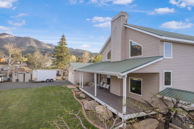 48 South Sage Road Pine Valley, UT 84781 - Photo 11 of 61 Two-story residence featuring light-toned siding, a green metal roof, and a covered front porch