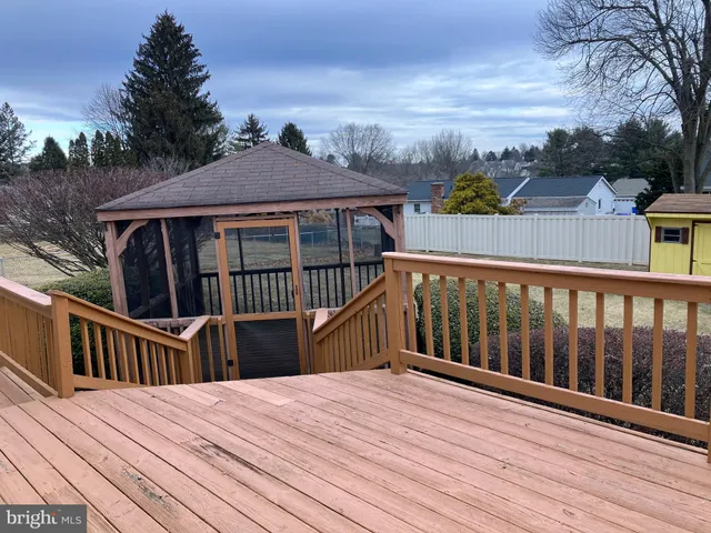a view of a house with wooden deck