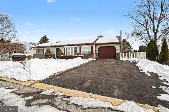 a view of a house with a snow in the background
