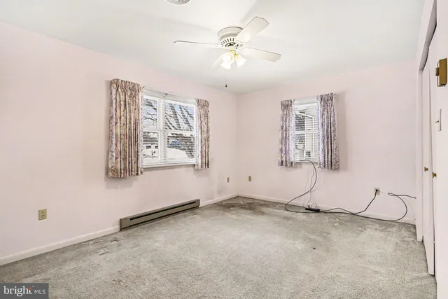 a view of a room with window and ceiling fan