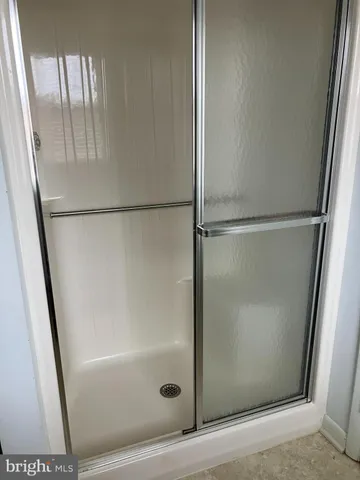 a bathroom with a glass shower door