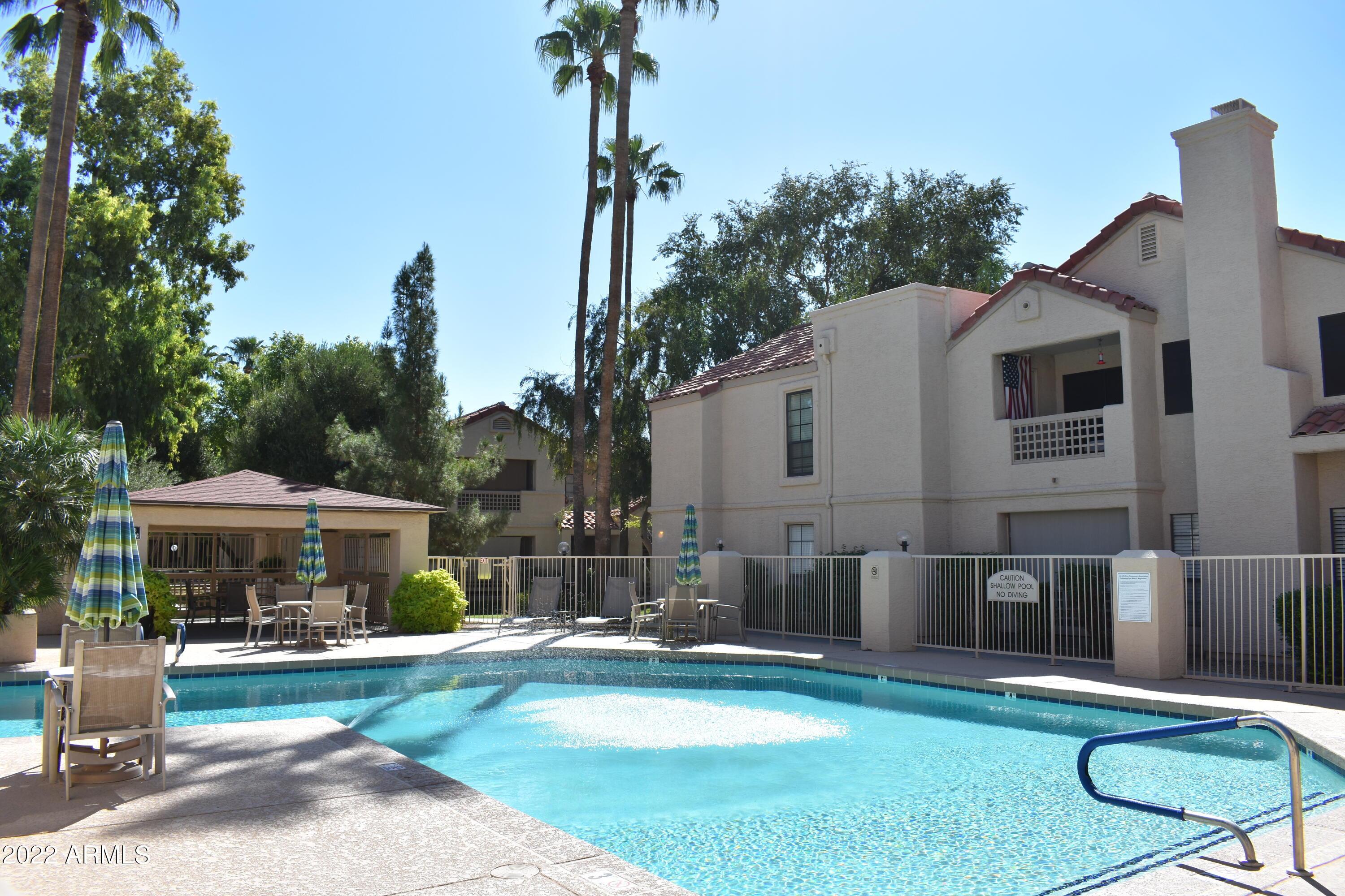 2855 South Ext Road, Unit 135 Mesa, AZ 85210 - Photo 16 of 19 a view of a house with backyard patio and swimming pool