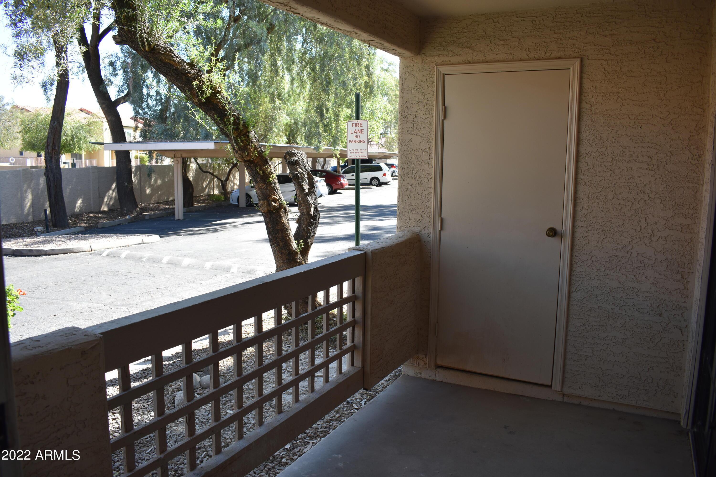 2855 South Ext Road, Unit 135 Mesa, AZ 85210 - Photo 8 of 19 a view of a porch with wooden floor and fence
