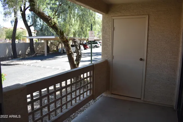 a view of a porch with wooden floor and fence